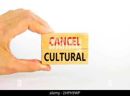 Cancel cultural symbol. Concept words Cancel cultural on wooden blocks on a beautiful white table white background. Businessman hand. Business and can Stock Photo