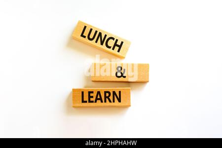 Lunch and learn symbol. Concept words Lunch and learn on wooden blocks. Beautiful white table white background. Copy space. Business, educational and Stock Photo