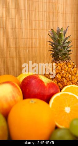 Spring or Summer concept. Many kinds of fruit. Vertical photo, can use for summer or food content background. Orange, apple, pineapple Stock Photo