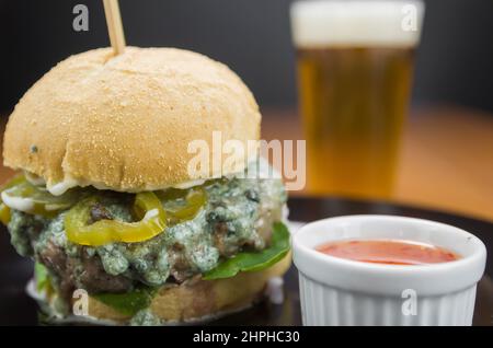 Close-up of tasty homemade hamburger on wooden table and black background Stock Photo
