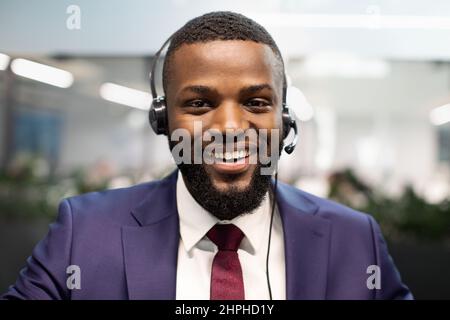 Closeup portrait of african american man in suit using headset Stock Photo
