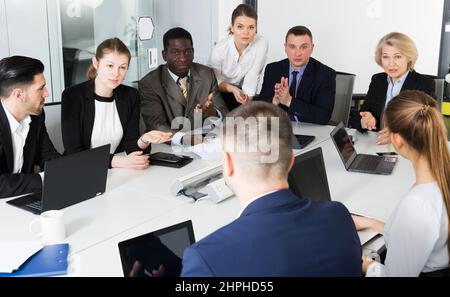 business partners discussing projects and ideas at meeting Stock Photo