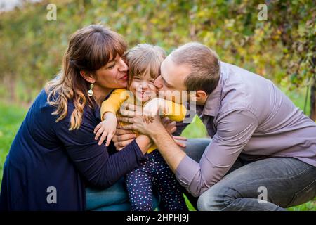 Portrait of happy family having fun together at a vineyard at sunny day Stock Photo