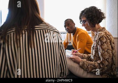 working group preparing a project with a laptop in an office. Stock Photo