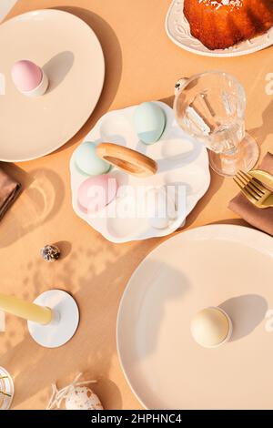 Top view background of elegant dinner table decorated for easter in sunlight, copy space Stock Photo