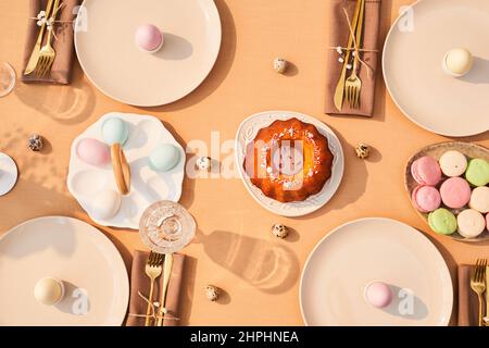 Top view background image of elegant dinner table decorated for Easter in sunlight, copy space Stock Photo