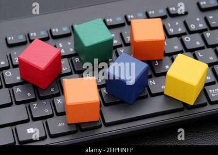 wooden toy blocks on computer keyboard on black table Stock Photo