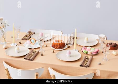 Minimal background image of elegant dinner table decorated for Easter and Spring, copy space Stock Photo