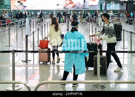 Hong Kong, China. 21st Feb, 2022. Passengers wait in a line at arrival hall as they need to go though quarantine at Hong Kong's Chek Lap Kok International Airport. Hong Kong is notoriously known for having one of the most restricted quarantines in the world is currently dealing with daily record covid cases. Credit: SOPA Images Limited/Alamy Live News Stock Photo