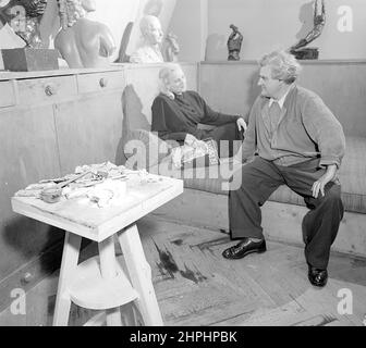 Gustinus Ambrosi (1893-1975), Austrian sculptor, in his studio. Probably with his wife Berta ca. June 1949 Stock Photo