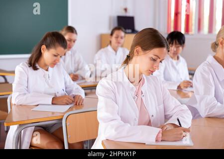 Medical students writing in notepads Stock Photo