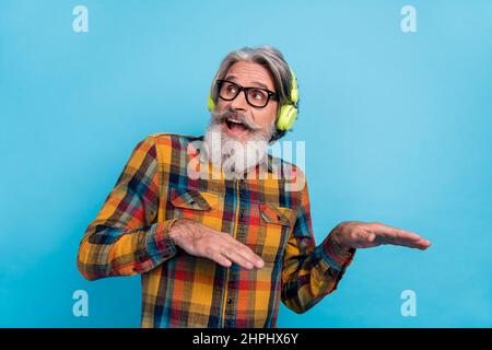 Photo of man pensioner dressed shirt glasses listening music dancing empty space isolated blue color background Stock Photo