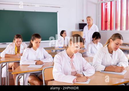 Medical students writing in notepads Stock Photo