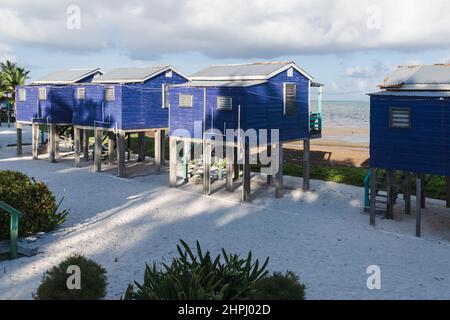 Typical wooden beach bungolow huts on stilts, called 'cabanas', at the beach of Caye Caulker, Belize Stock Photo