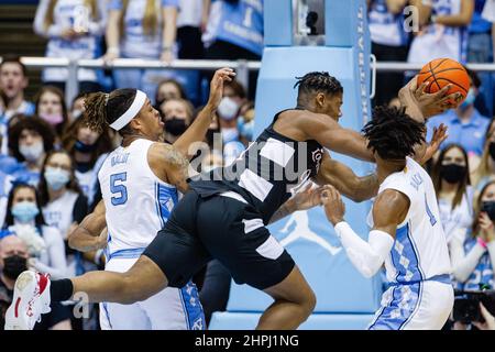 Chapel Hill, NC, USA. 21st Feb, 2022. Louisville Cardinals forward Sydney Curry (21) as the ball knocked away by North Carolina Tar Heels guard Leaky Black (1) during the first half of the ACC basketball matchup at Dean Smith Center in Chapel Hill, NC. (Scott Kinser/Cal Sport Media). Credit: csm/Alamy Live News Stock Photo