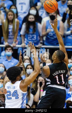 Charlottesville, Virginia, USA. 24th Jan, 2022. Louisville Cardinals guard  Mason Faulkner (11) shoots over Virginia guard Kihei Clark (0) during NCAA  basketball game between the Virginia Cavaliers and the Louisville Cardinals  at