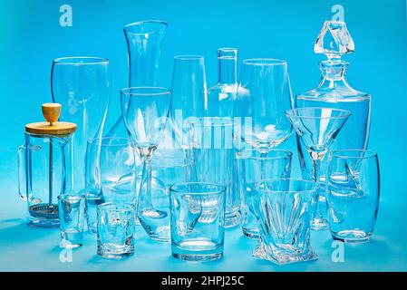 Set of empty different glasses on a blue background. alcoholic drinks and cocktails glassware Stock Photo