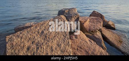Granite stones, cobblestones on the river bank Stock Photo