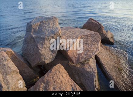 Granite stones, cobblestones on the river bank Stock Photo