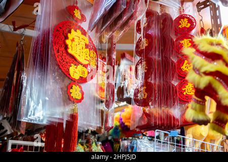 Chinese ornaments hung up in shops at market during Chinese New Year Stock Photo