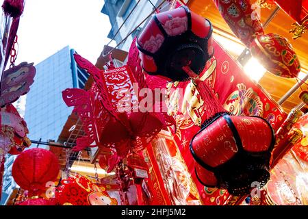 Chinese ornaments hung up in shops at market during Chinese New Year Stock Photo