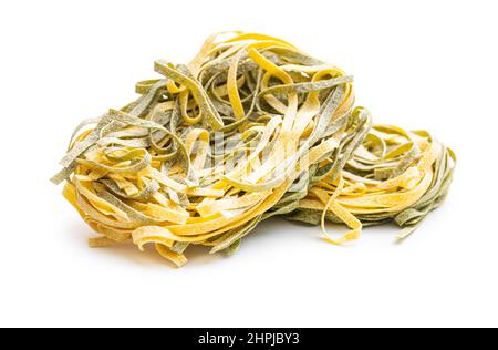 Egg pasta. Noodles nest with spinach flavor isolated on white background. Stock Photo