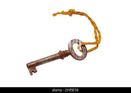 Vintage keys isolated. Close-up of an old rusty key of an old large padlock hanging on a string isolated on a white background. Antique objects. Macro Stock Photo