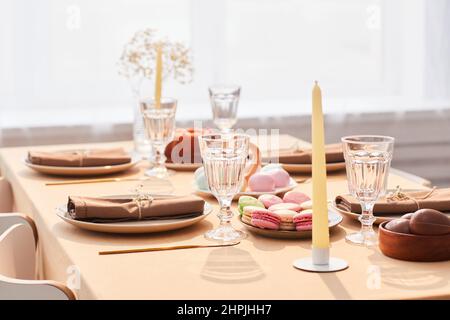 Background image of elegant dinner table decorated for Easter in soft and airy tones, copy space Stock Photo