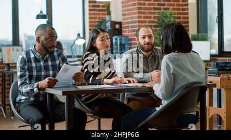 Angry woman leaving job meeting after getting dismissed, losing employment. Shocked person in despair being fired from office work, feeling worried about failed business career. Stock Photo