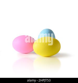 Easter three colorful yellow, pink and blue chicken eggs isolated on white background. Stock Photo