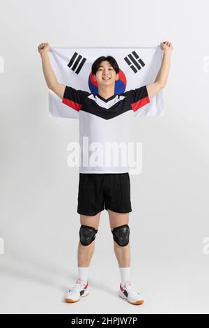 volleyball sports player, asian korean man holding Korean flag Taegeukgi Stock Photo