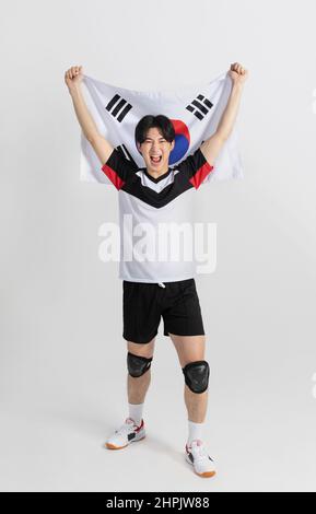 volleyball sports player, asian korean man holding Korean flag Taegeukgi Stock Photo