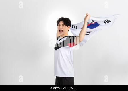 volleyball sports player, asian korean man holding Korean flag Taegeukgi Stock Photo