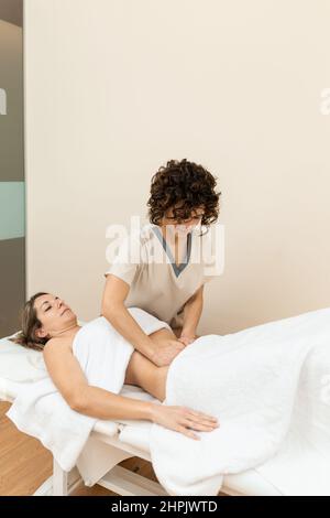 A therapist giving abdominal massage in female patient Stock Photo - Alamy