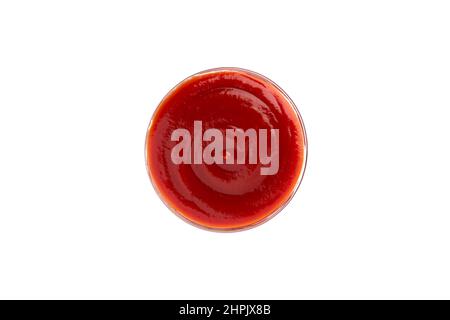 Red tomato sauce in a bowl isolated on white background, single object from above, top view. Ketchup in a glass saucer Stock Photo