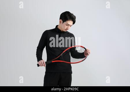 tennis sports player, asian korean man with racket, studio Stock Photo