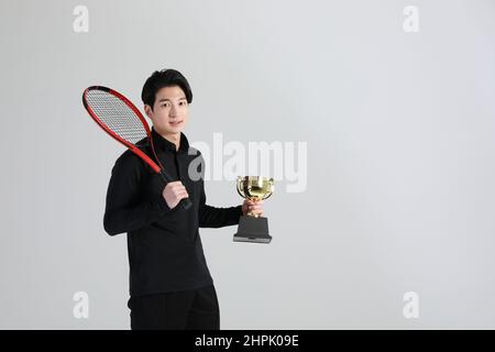 tennis sports player, asian korean man with trophy, studio Stock Photo