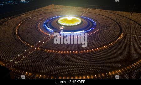 Monks participate in the Makha Bucha Ceremony at Wat Phra Dhammakaya during their 52nd Anniversary. The virtual ceremony was organized by lighting 1 million lanterns to pay homage to Buddha. Stock Photo