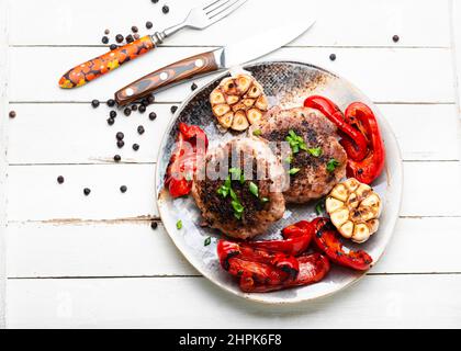 Grilled beef steak, beef and pork with spices. Fried meat in bacon. Stock Photo
