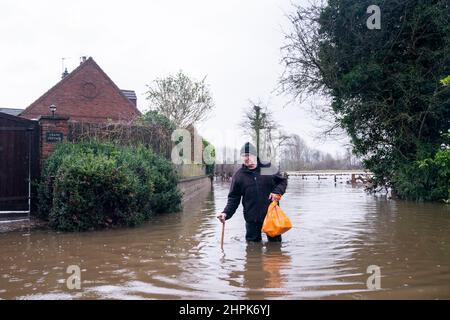 Mick Malkinson walks through flood water near his home in Tadcaster after the River Wharfe overtopped its banks. The Environment Agency has urged communities in parts of the West Midlands and the north of England, especially those along River Severn, to be prepared for significant flooding until Wednesday following high rainfall from Storm Franklin. Picture date: Tuesday February 22, 2022.