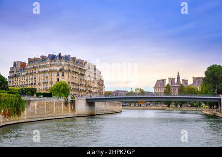 View of the embankment of the River Seine in the evening, the historic quarters of Paris Stock Photo