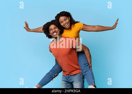 Pretty african american woman riding her lover back Stock Photo