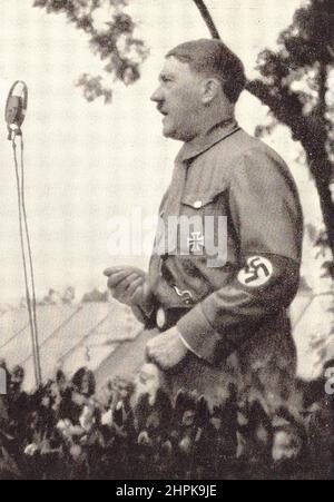 Adolf Hitler in front of a microphone. The Fuhrer speaks to the youth. Germany, 1930s. Stock Photo