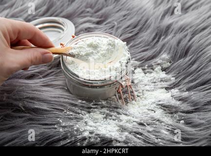 Woman Hand Cleaning Stain On Carpet With hard brush. Orange carpet