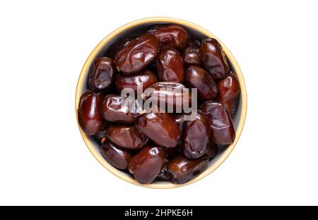 Full bowl of dried dates isolated on white. Stock Photo