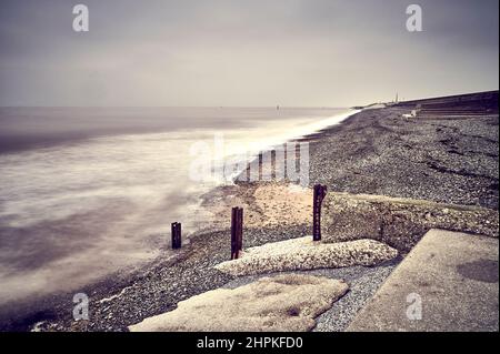 Stormy sea waves breaking over old sea defences at Rossall,Fleetwood Stock Photo