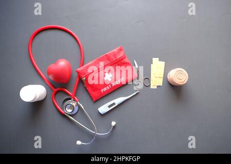 top view of first aid kit and stethoscope on black background  Stock Photo