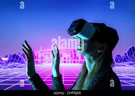 Female person using Virtual reality headset in metaverse universe. Experiencing virtual reality internet metaverse Stock Photo