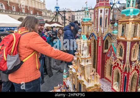 Radio reporter interviewing, Kraków Szopka nativity scenes displayed during annual contest in December, event included in UNESCO Cultural Heritage list, at Adam Mickiewicz monument, Main Market Square, Kraków, Poland Stock Photo