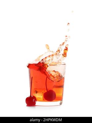 Glass of tasty Manhattan cocktail with splashes isolated on white background Stock Photo